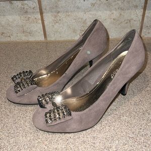 Faux suede pumps with jeweled design detail.